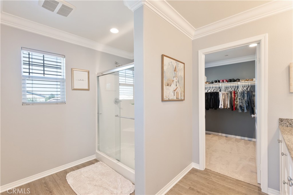 30283 Ramsay Drive Menifee, CA 92584 - Photo 15 of 24 a view of a hallway with bathroom and mirror