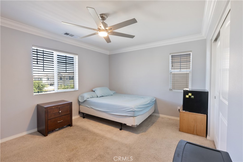 30283 Ramsay Drive Menifee, CA 92584 - Photo 20 of 24 a bedroom with a bed and a tv
