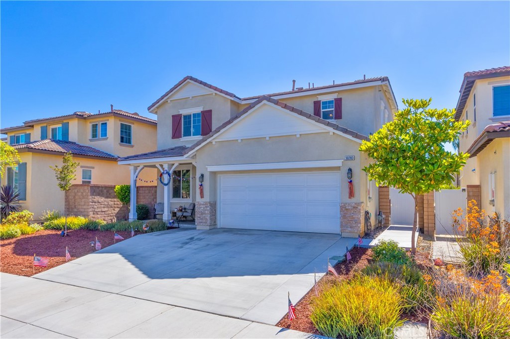 30283 Ramsay Drive Menifee, CA 92584 - Photo 3 of 24 a front view of a house with garden