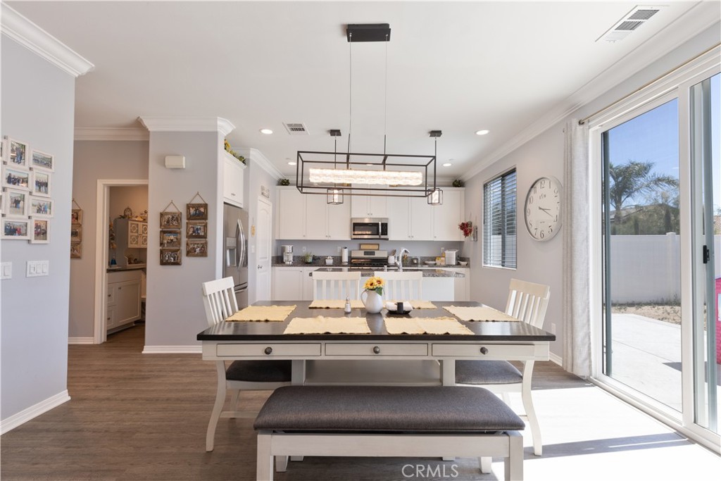 30283 Ramsay Drive Menifee, CA 92584 - Photo 8 of 24 a room with granite countertop lots of wooden furniture and glass door