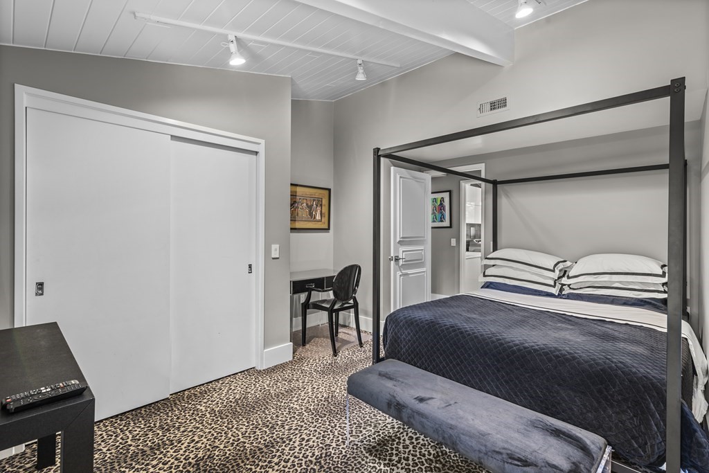 43 Peregrine Road Newton, MA 02459 - Photo 25 of 42 a bedroom with a bed and a table in it