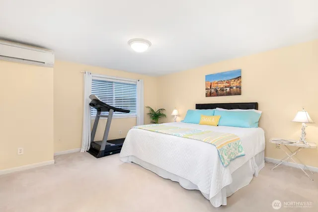 a bedroom with a bed and a large mirror