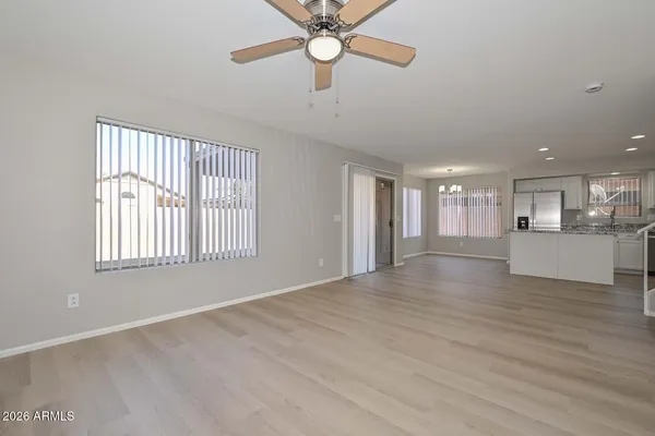 a view of kitchen with kitchen island microwave oven stove and white cabinets