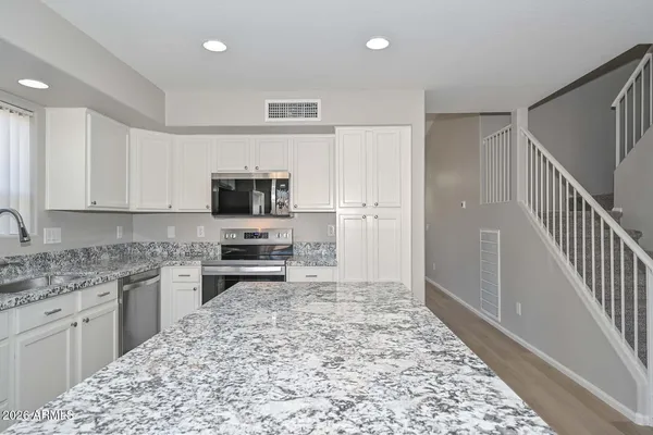 a kitchen with a stove a sink and a refrigerator