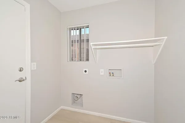an empty room with wooden floor ceiling fan and windows