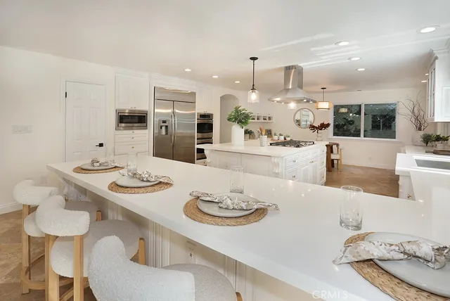 a large kitchen with a table and chairs in it