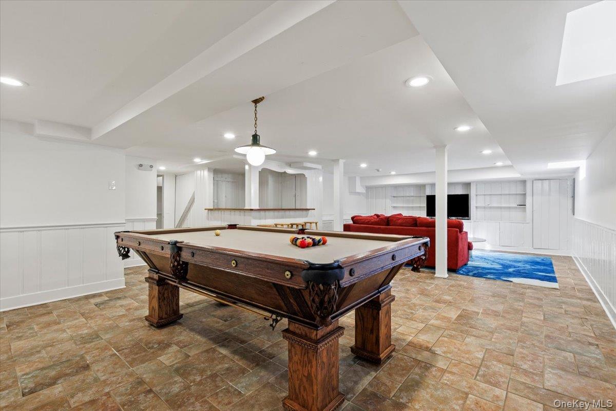 46 Fenimore Road Scarsdale, NY 10583 - Photo 28 of 35 Finished basement includes this open area for playing pool or other games. Also in the basement, there is a full bath, laundry, a wet bar, and a workshop.