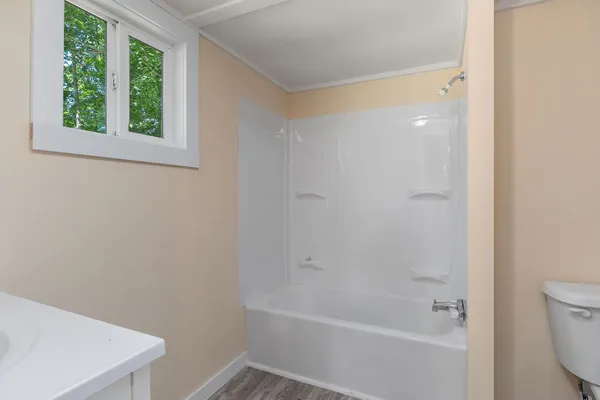 a white bath tub sitting next to a white toilet