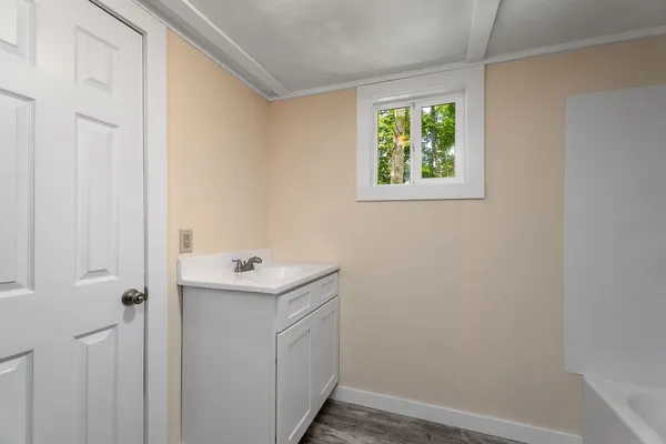 a bathroom with a sink and a window