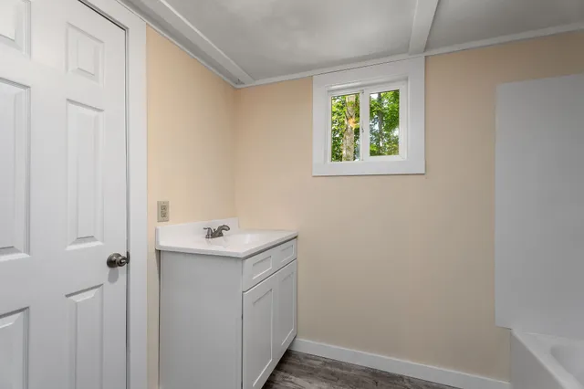 a bathroom with a sink and a window