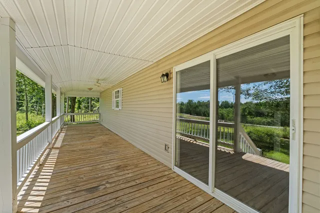 a view of a balcony with wooden floor