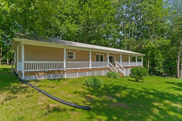 a view of a house with a backyard