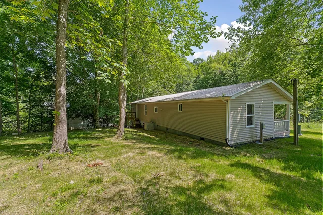a view of a barn in the middle of a yard