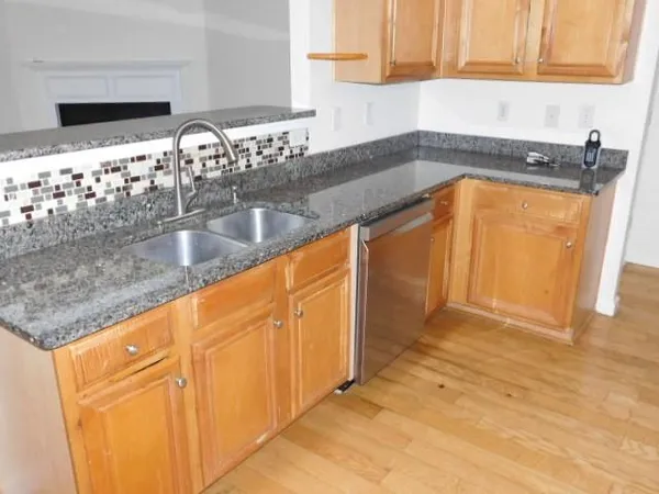 a kitchen with granite countertop a sink and a stove