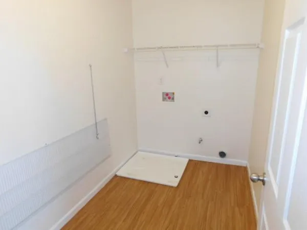 a view of a room with wooden floor