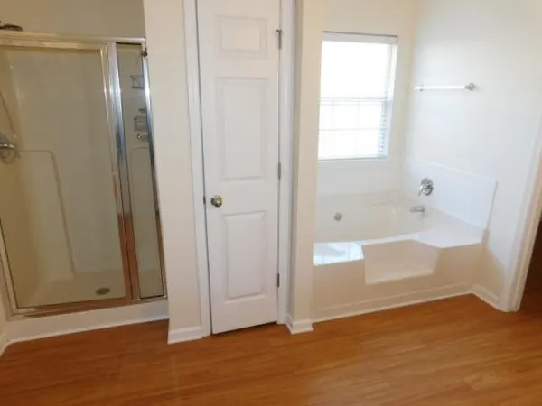 a bathroom with a bathtub and shower