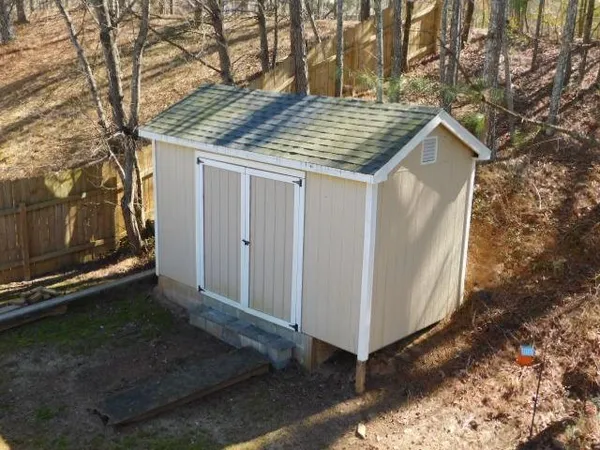 a view of a backyard with wooden fence