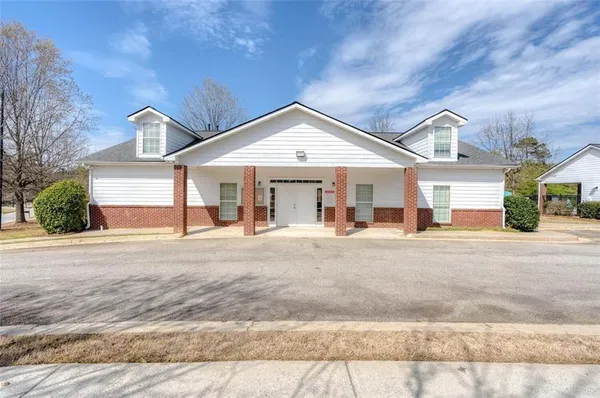 a view of a house with pool and chairs
