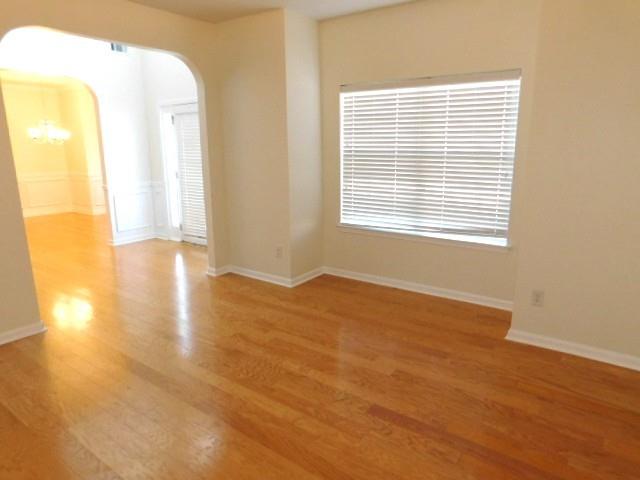 4304 Defoors Farm Trail Powder Springs, GA 30127 - Photo 6 of 41 a view of an empty room with wooden floor and a window