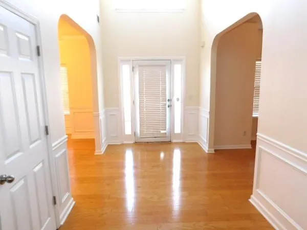 a view of a room with wooden floor and a window