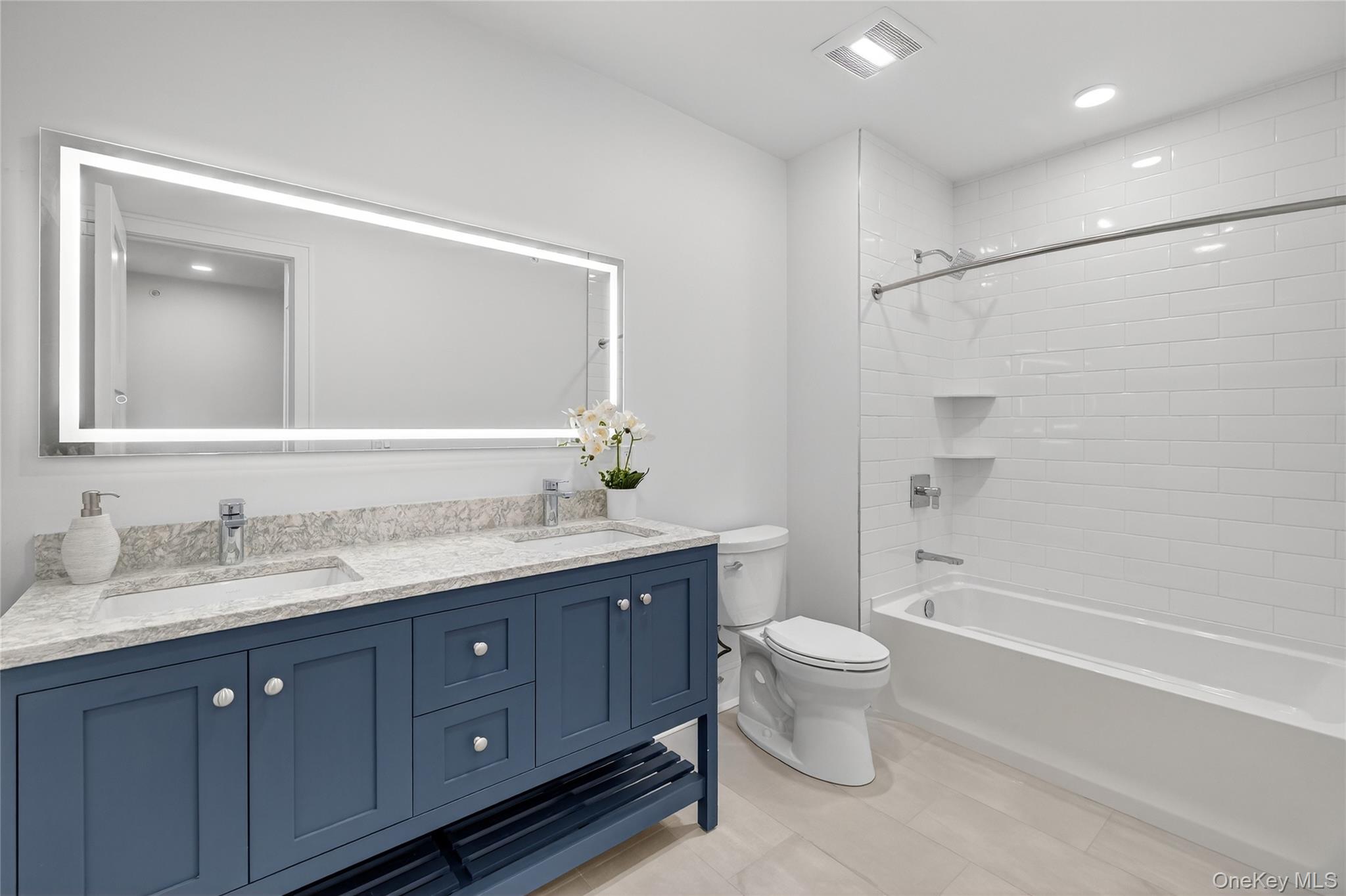 1801 Soundview Court Yorktown Heights, NY 10598 - Photo 22 of 33 a bathroom with a double vanity sink toilet mirror and shower
