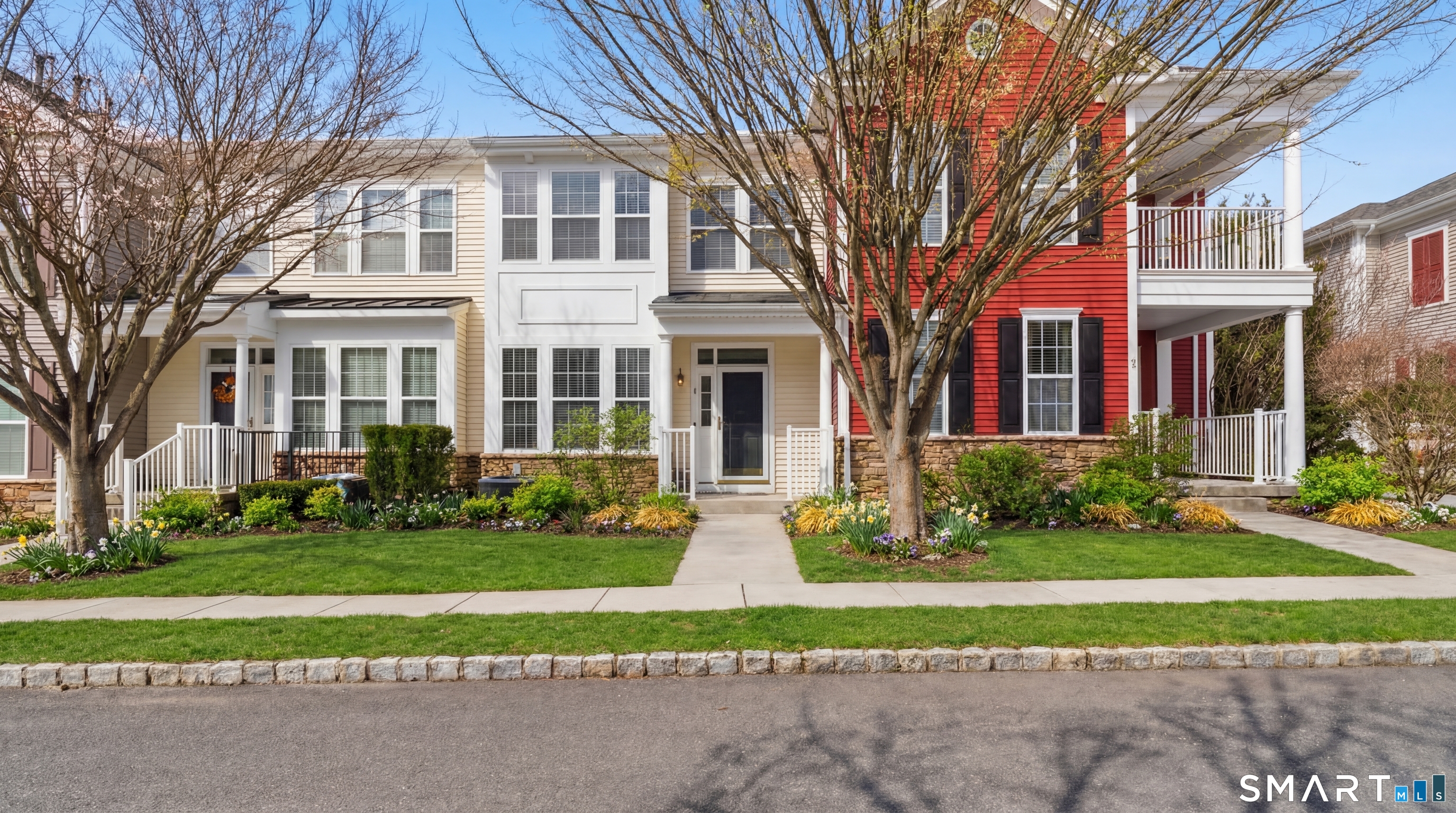 13 Mercy Street, Unit 13 Danbury, CT 06810 - Photo 1 of 40 a front view of a house with a yard