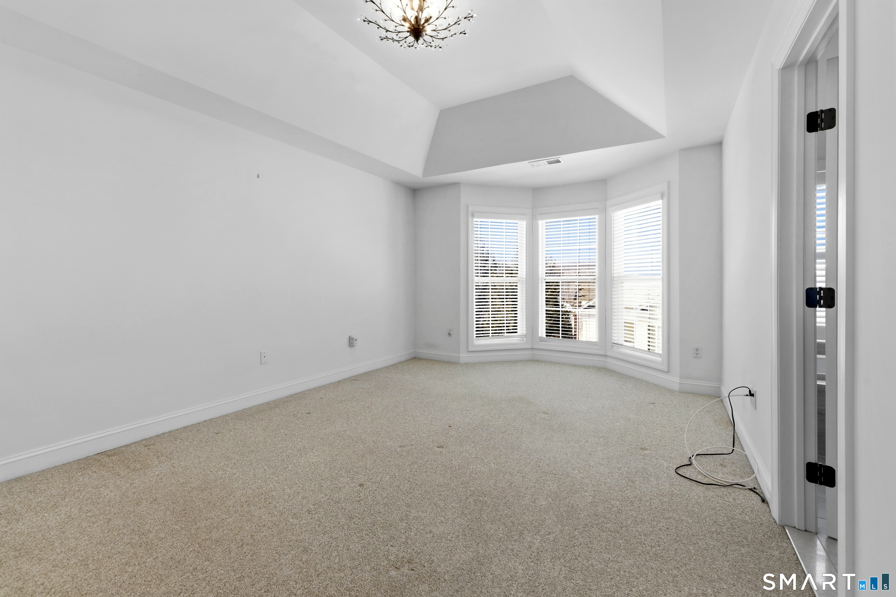 13 Mercy Street, Unit 13 Danbury, CT 06810 - Photo 16 of 40 an empty room with windows and closet