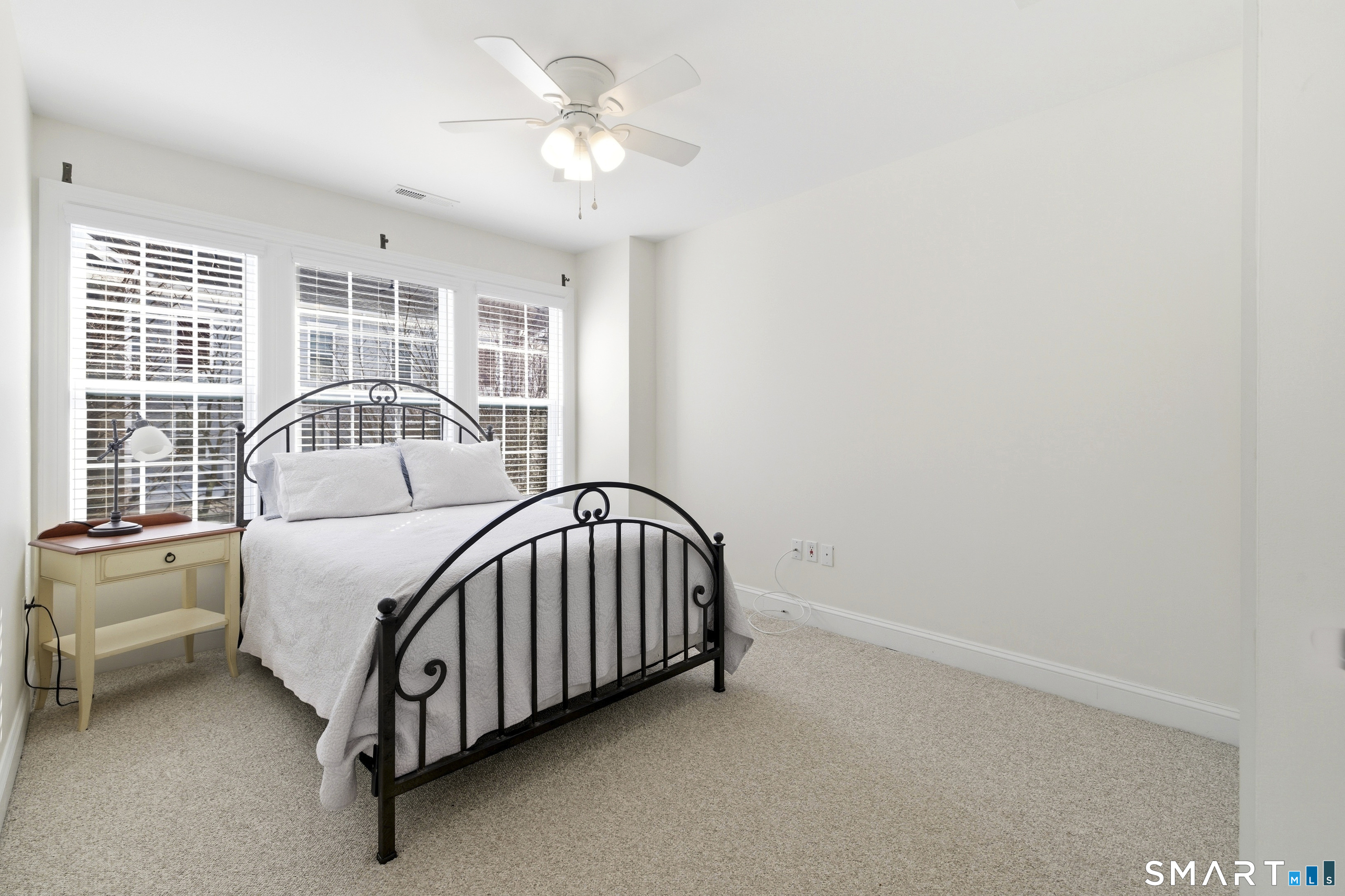 13 Mercy Street, Unit 13 Danbury, CT 06810 - Photo 23 of 40 a view of a bedroom with a bed and a window