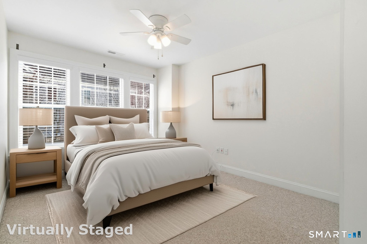 13 Mercy Street, Unit 13 Danbury, CT 06810 - Photo 24 of 40 a bedroom with a bed painting on wall and a large window