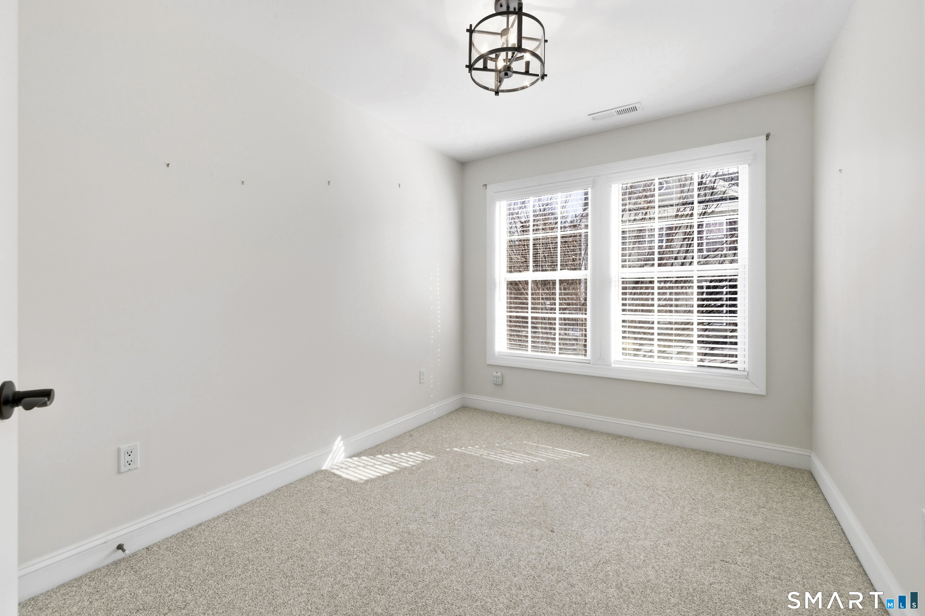 13 Mercy Street, Unit 13 Danbury, CT 06810 - Photo 25 of 40 a view of an empty room with a window
