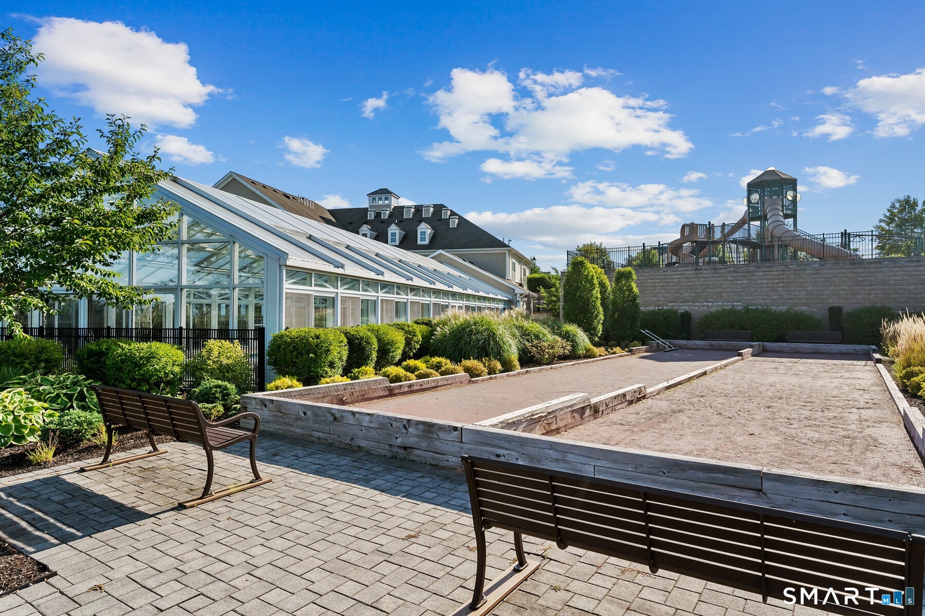 13 Mercy Street, Unit 13 Danbury, CT 06810 - Photo 40 of 40 a view of a patio with a table and chairs and potted plants