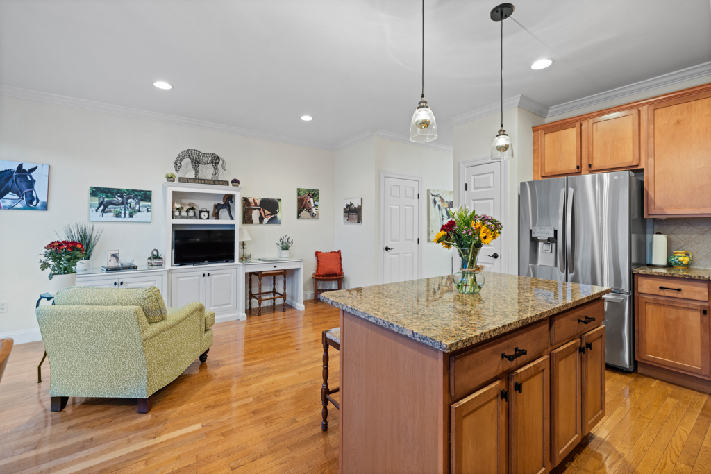 13 Mercy Street, Unit 13 Danbury, CT 06810 - Photo 9 of 40 a kitchen with stainless steel appliances granite countertop a stove refrigerator a dining table and chairs with wooden floor