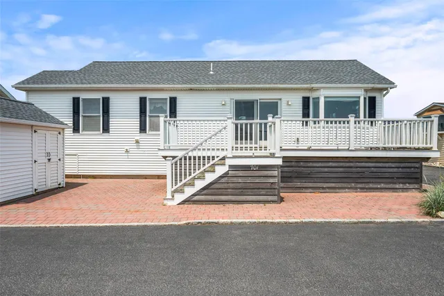 a view of a house with wooden fence