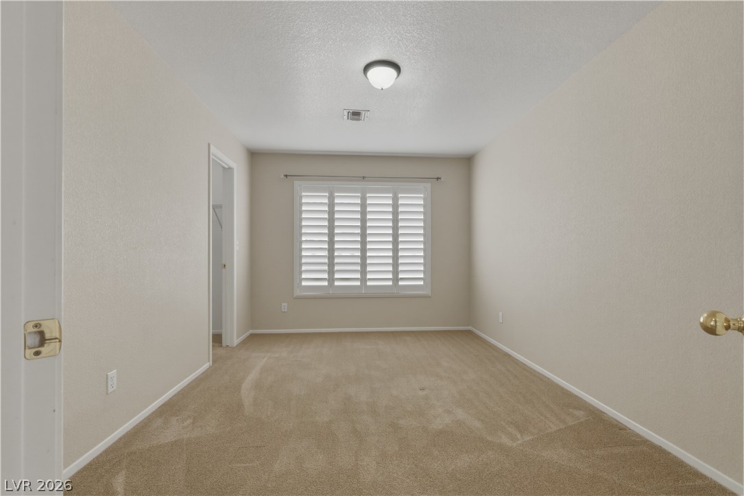29 Olive Tree Henderson, NV 89074 - Photo 46 of 60 This spacious room offers comfort and versatility, perfect for a cozy retreat or dynamic living area.