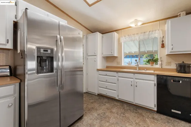 a kitchen with stainless steel appliances a refrigerator sink and cabinets