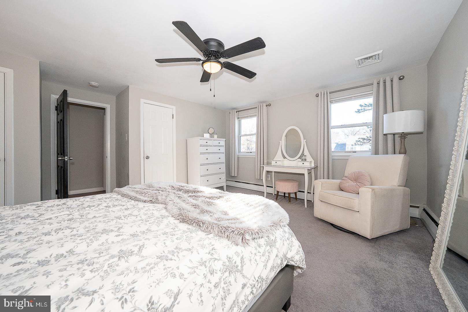 334 Parham Road Springfield, PA 19064 - Photo 19 of 45 a spacious bedroom with a bed a couch and a chandelier