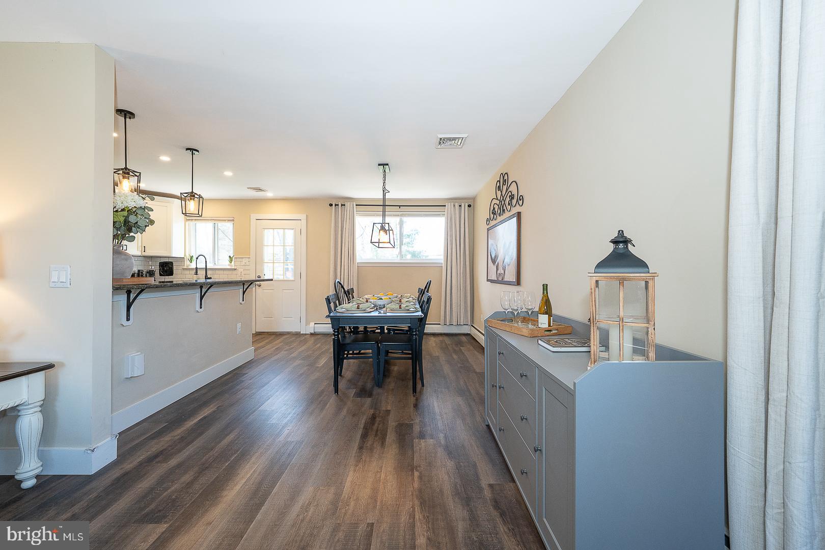 334 Parham Road Springfield, PA 19064 - Photo 6 of 45 a kitchen with kitchen island wooden floors and stainless steel appliances