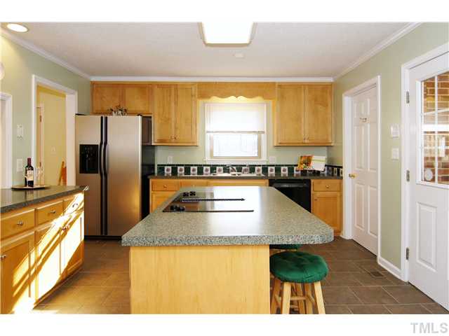 933 Allister Road Durham, NC 27703 - Photo 6 of 20 Large Island/Bar, Cooktop, Tile Backsplash and Tile flooring are one of the many features of this Kitchen.