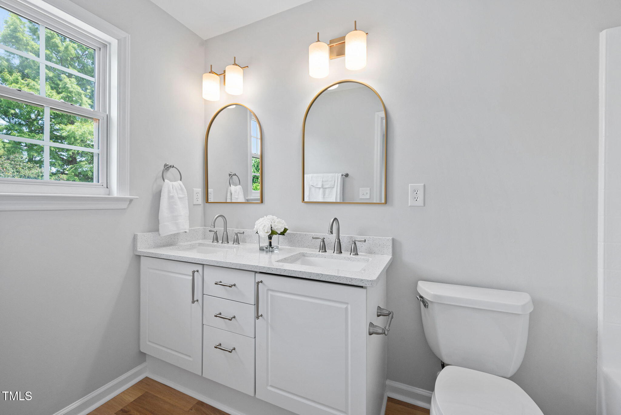 2040 Persimmon Ridge Drive Raleigh, NC 27604 - Photo 20 of 39 a bathroom with a toilet sink and mirror