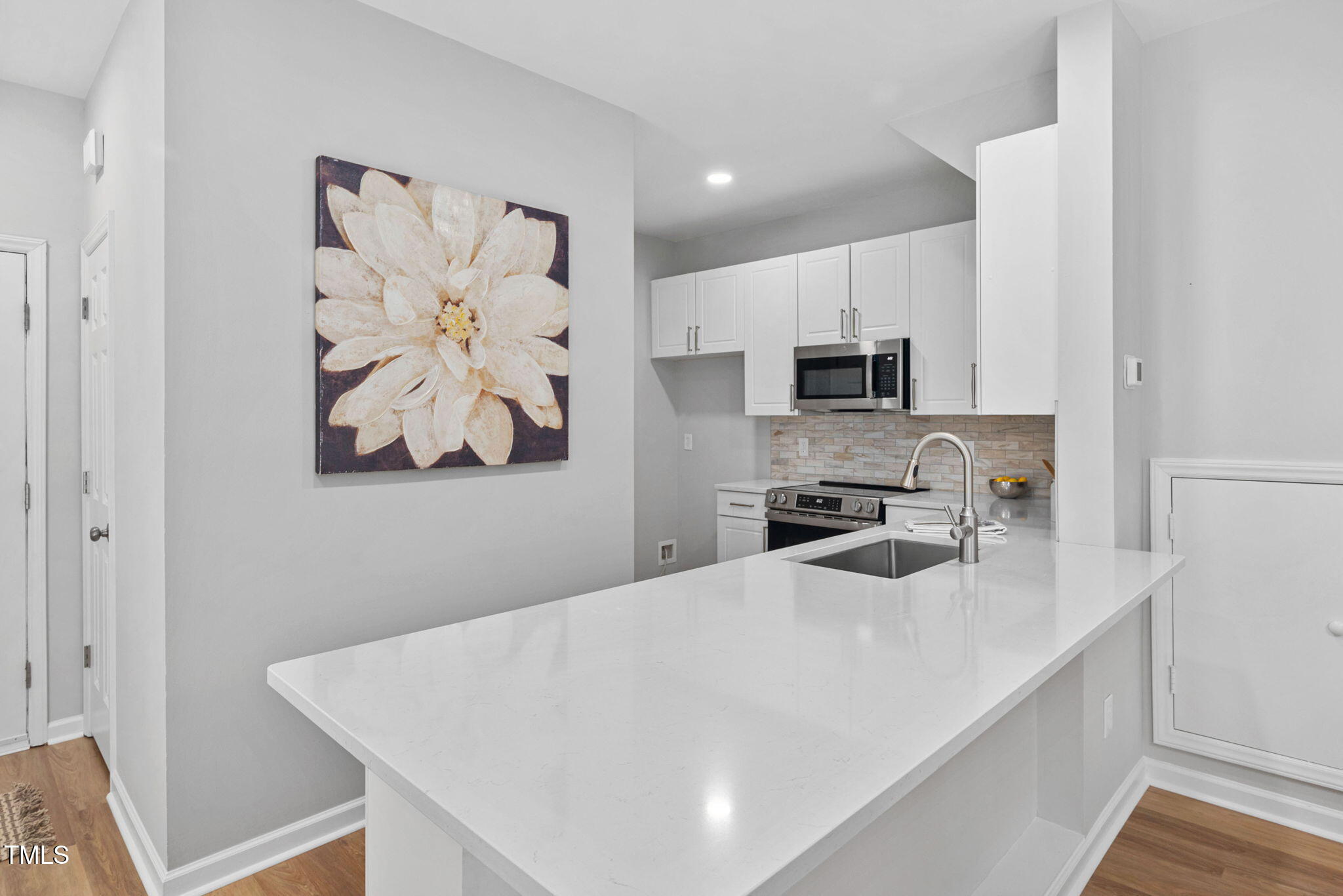 2040 Persimmon Ridge Drive Raleigh, NC 27604 - Photo 2 of 39 a kitchen with stainless steel appliances a microwave a sink and a refrigerator
