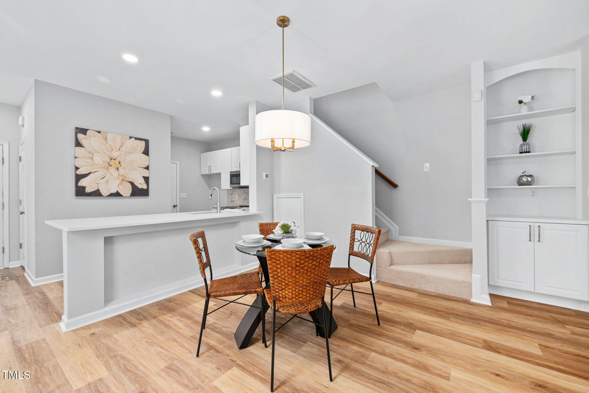 2040 Persimmon Ridge Drive Raleigh, NC 27604 - Photo 5 of 39 a dining room with wooden floor a glass table and chairs