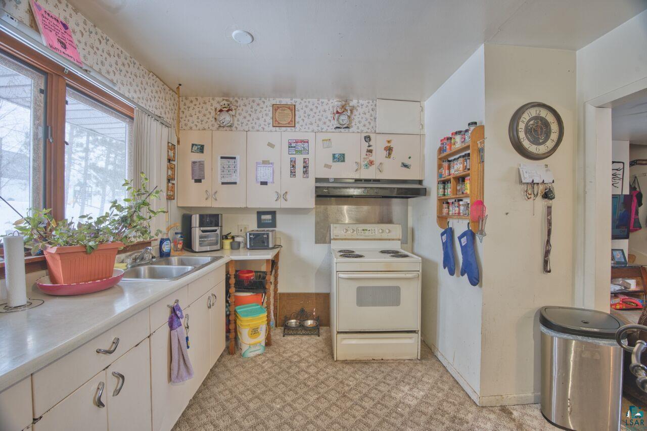 417 Arlington Road Hoyt Lakes, MN 55750 - Photo 3 of 32 Kitchen with white electric stove, light flooring, light countertops, and white cabinets
