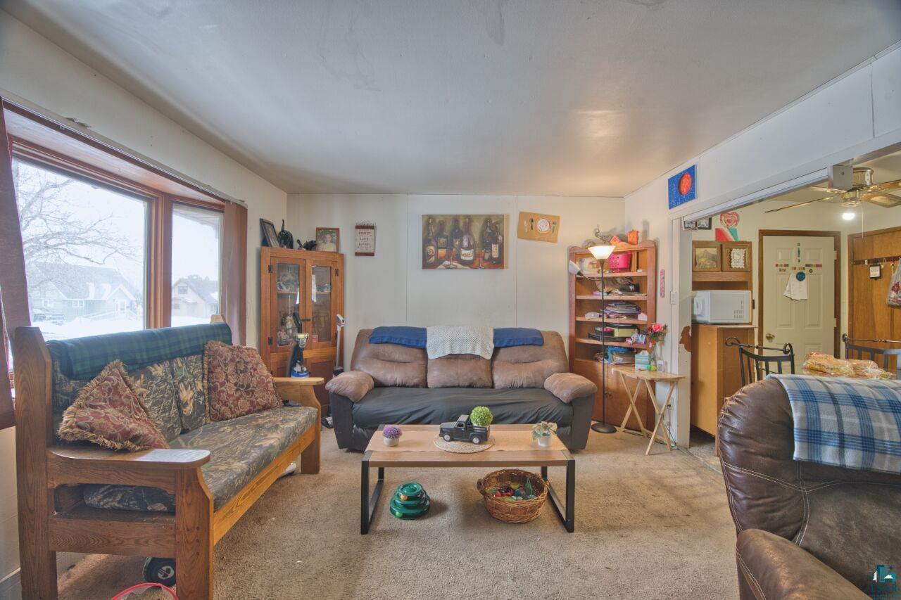 417 Arlington Road Hoyt Lakes, MN 55750 - Photo 6 of 32 Living area with carpet floors and ceiling fan