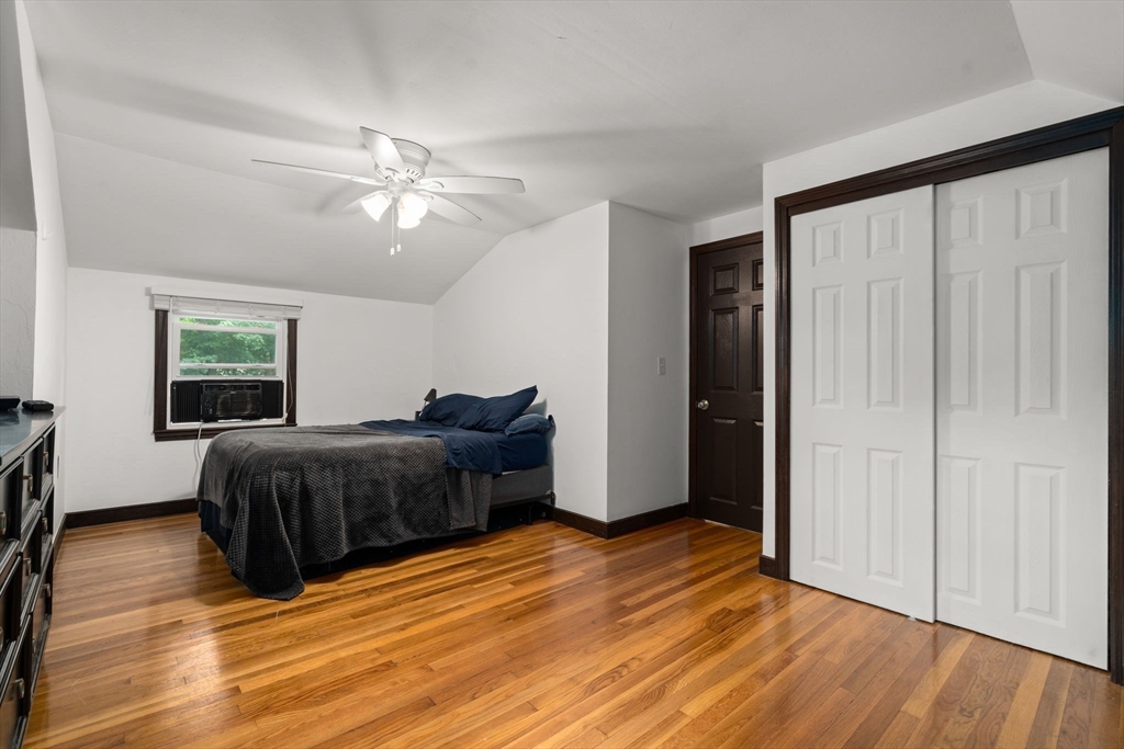 9 Laurel Lane Bellingham, MA 02019 - Photo 25 of 30 a bedroom with a bed and wooden floor