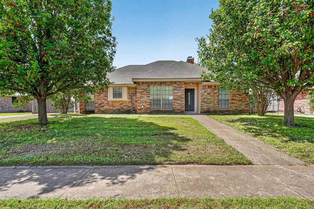 2403 Ridgevalley Drive McKinney, TX 75071 - Photo 1 of 21 a front view of a house with a garden