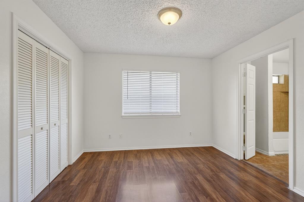 2403 Ridgevalley Drive McKinney, TX 75071 - Photo 14 of 21 an empty room with wooden floor and windows