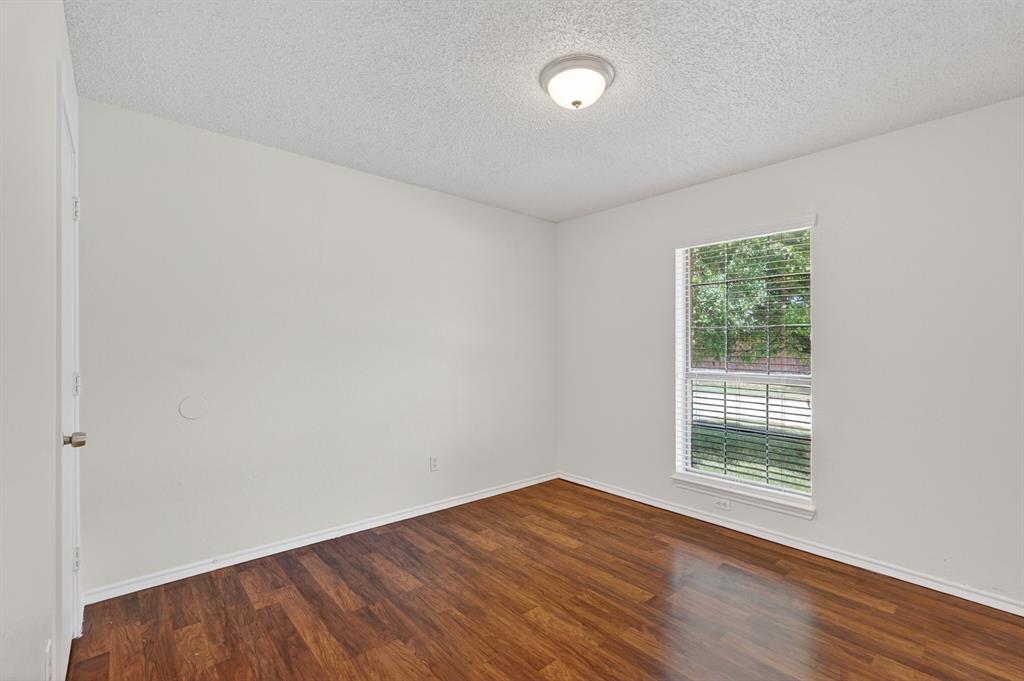 2403 Ridgevalley Drive McKinney, TX 75071 - Photo 15 of 21 an empty room with wooden floor and windows