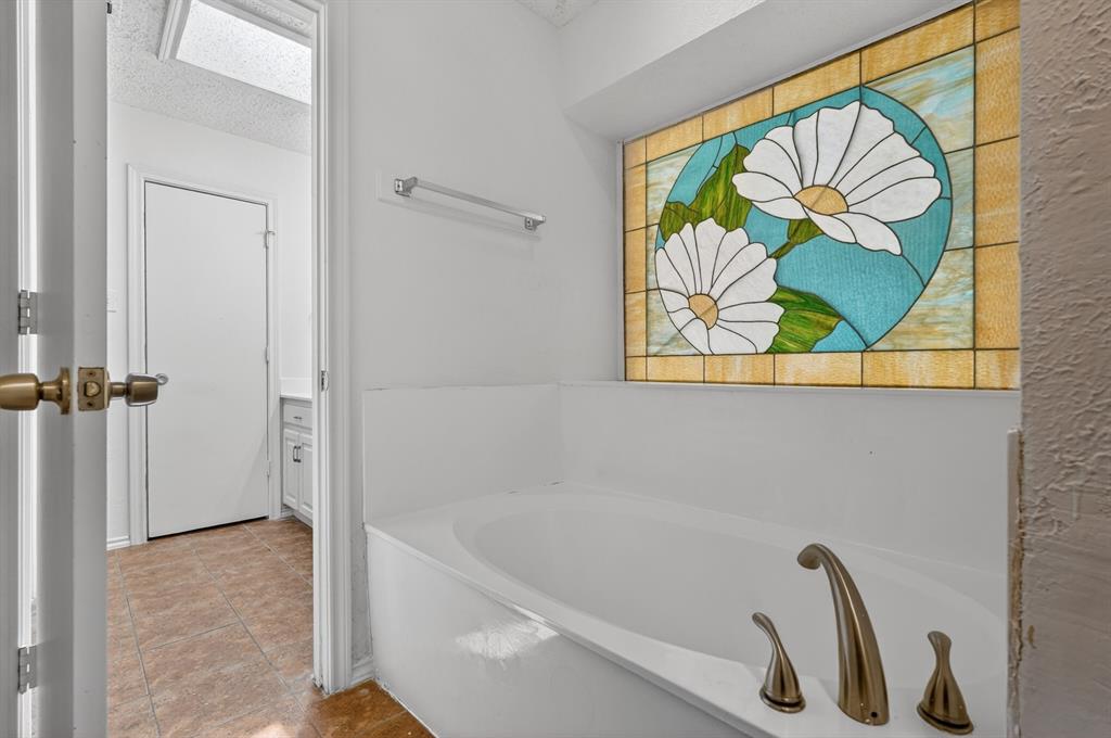 2403 Ridgevalley Drive McKinney, TX 75071 - Photo 18 of 21 a bathroom with a bathtub