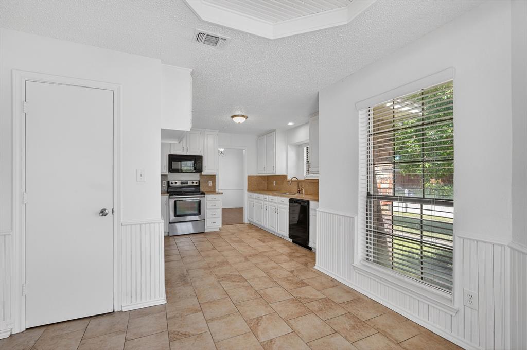 2403 Ridgevalley Drive McKinney, TX 75071 - Photo 6 of 21 a open kitchen with white cabinets and a refrigerator