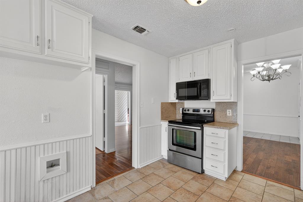 2403 Ridgevalley Drive McKinney, TX 75071 - Photo 7 of 21 a kitchen with stainless steel appliances granite countertop a refrigerator and a stove top oven
